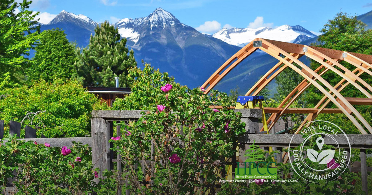 Why-Supporting-Local-Matters-when-Building-Your-Custom-Greenhouse Beautiful image of an Argenta Greenhouse being constructed at the base of the Purcell Mountains